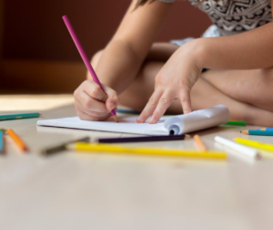 Child coloring an Advent page with Bible verses